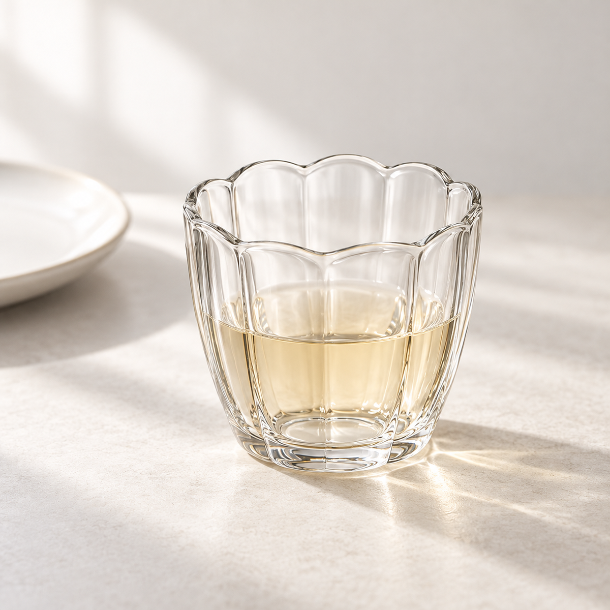 Petal Scalloped Glass Set - one cup in an everyday table setting